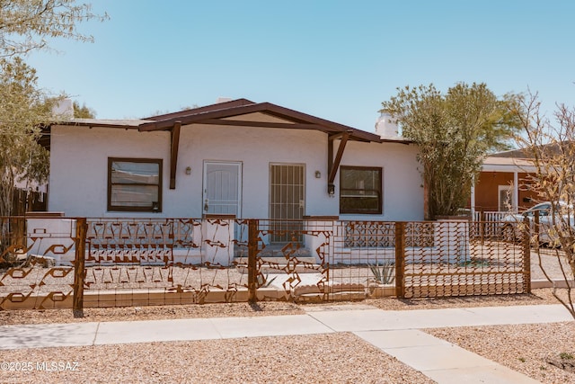 616 E 8th St, Tucson, AZ 85705 - view of front facade with a fenced front yard and stucco siding