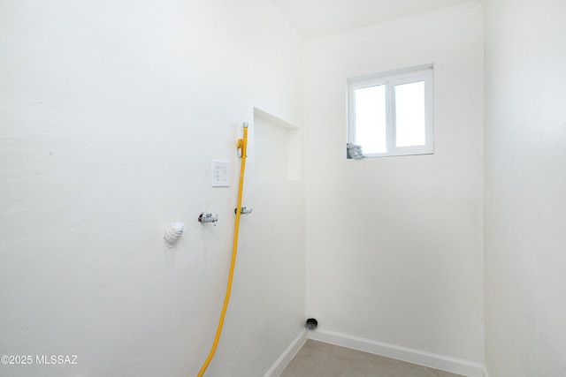 laundry area with baseboards