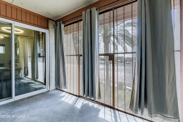 unfurnished sunroom featuring carpet floors