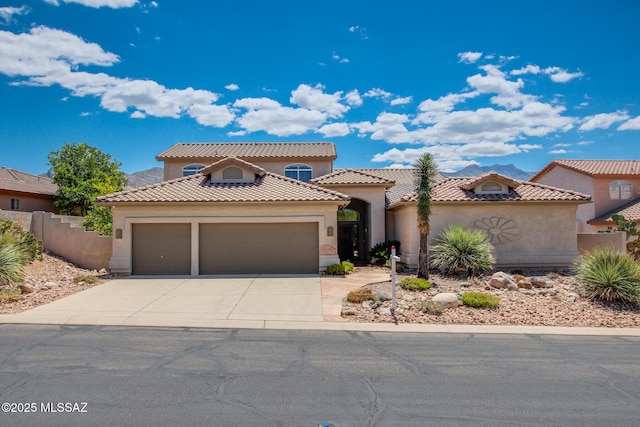 36359 S Wind Crest Dr, Saddlebrooke, AZ 85739 - mediterranean / spanish home featuring a garage, driveway, stucco siding, and fence
