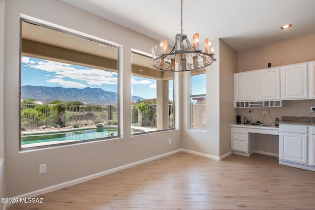 36359 S Wind Crest Dr, Saddlebrooke, AZ 85739 - unfurnished dining area featuring a mountain view, a chandelier, light wood finished floors, recessed lighting, and baseboards