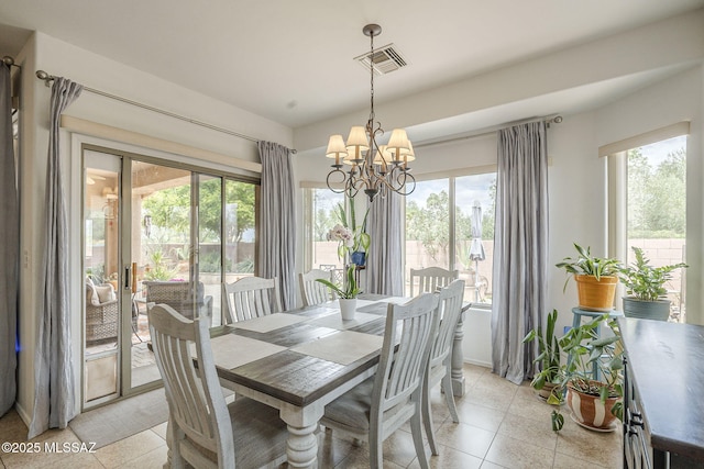 825 E Gunsight Mountain Pl, Sahuarita, AZ 85629 - dining room with light tile patterned floors, a chandelier, and french doors