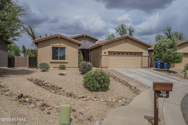 825 E Gunsight Mountain Pl, Sahuarita, AZ 85629 - view of front facade with an attached garage, concrete driveway, stucco siding, fence, and a tile roof