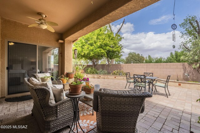825 E Gunsight Mountain Pl, Sahuarita, AZ 85629 - view of patio / terrace with a ceiling fan, outdoor dining space, a fenced backyard, and an outdoor living space
