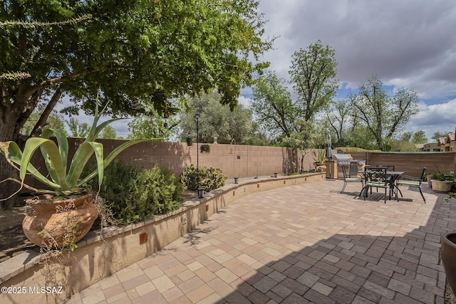 825 E Gunsight Mountain Pl, Sahuarita, AZ 85629 - view of patio / terrace with a fenced backyard and outdoor dining space
