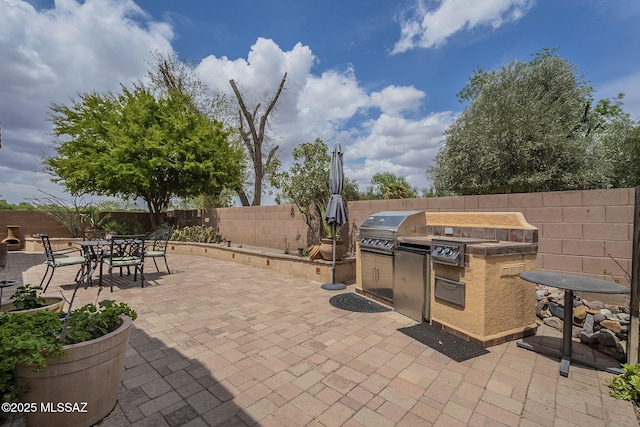 825 E Gunsight Mountain Pl, Sahuarita, AZ 85629 - view of patio / terrace featuring grilling area, area for grilling, a fenced backyard, and outdoor dining space