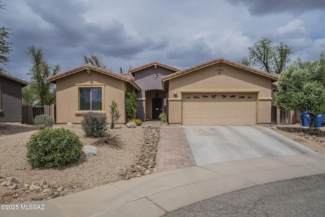 825 E Gunsight Mountain Pl, Sahuarita, AZ 85629 - view of front of house featuring stucco siding, an attached garage, concrete driveway, a tile roof, and fence