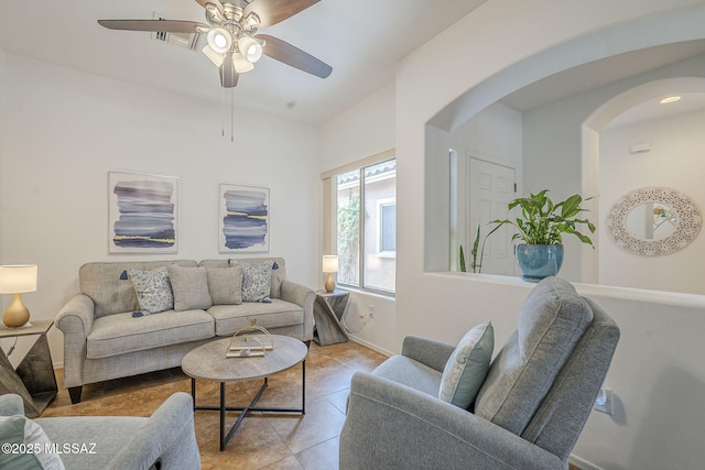 825 E Gunsight Mountain Pl, Sahuarita, AZ 85629 - living area with arched walkways, light tile patterned floors, a ceiling fan, baseboards, and lofted ceiling
