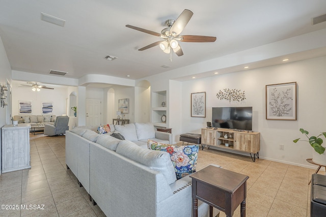825 E Gunsight Mountain Pl, Sahuarita, AZ 85629 - living area with arched walkways, ceiling fan, light tile patterned floors, built in features, and recessed lighting