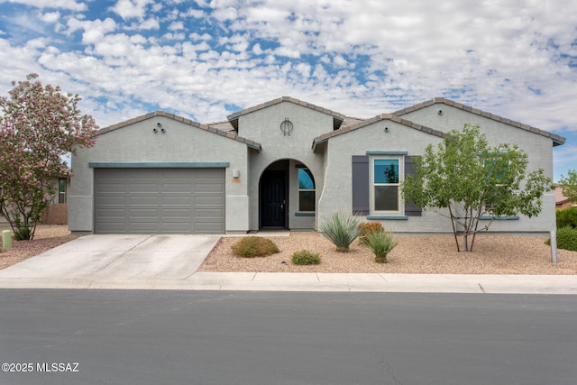 12493 N Blondin Dr, Marana, AZ 85653 - mediterranean / spanish-style home featuring an attached garage, concrete driveway, a tile roof, and stucco siding