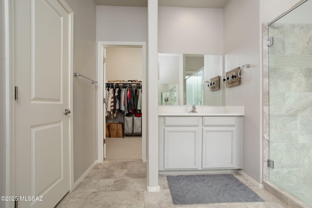 12493 N Blondin Dr, Marana, AZ 85653 - bathroom featuring a shower stall, vanity, a spacious closet, and baseboards