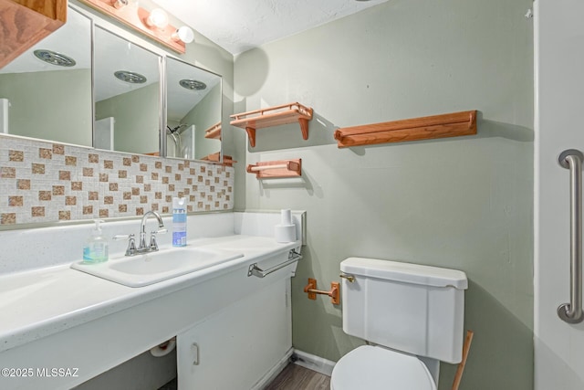 8150 E Broadway Blvd Unit H-107, Tucson, AZ 85710 - bathroom featuring backsplash, toilet, and vanity