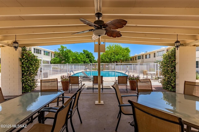 8150 E Broadway Blvd Unit H-107, Tucson, AZ 85710 - view of patio / terrace featuring outdoor dining space, a community pool, and ceiling fan