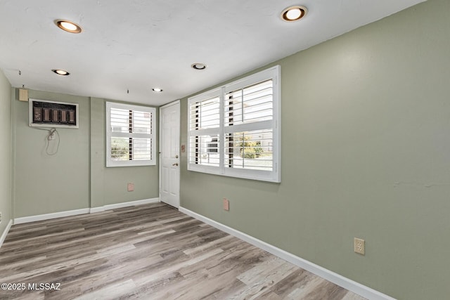 8150 E Broadway Blvd Unit H-107, Tucson, AZ 85710 - unfurnished room featuring baseboards, wood finished floors, and recessed lighting