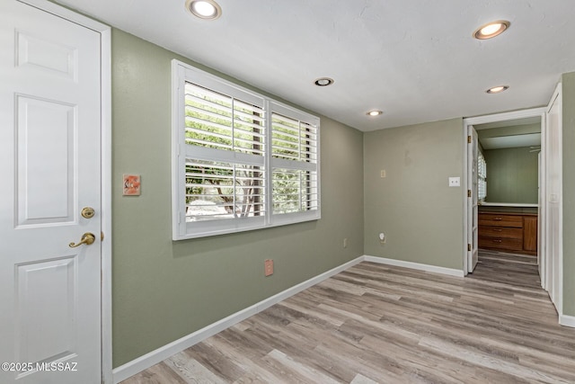 8150 E Broadway Blvd Unit H-107, Tucson, AZ 85710 - unfurnished room with wood finished floors, baseboards, and recessed lighting