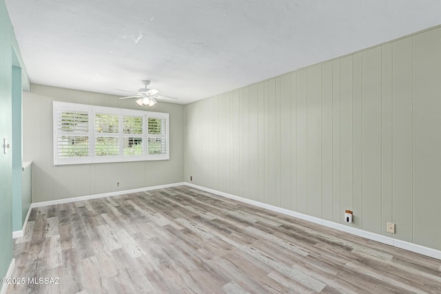 8150 E Broadway Blvd Unit H-107, Tucson, AZ 85710 - spare room featuring wood finished floors, ceiling fan, and baseboards