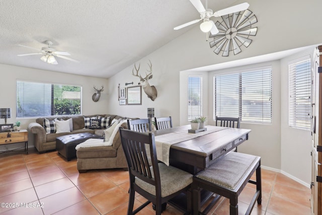 1861 W Sauvignon Dr, Tucson, AZ 85746 - dining space featuring ceiling fan, light tile patterned floors, lofted ceiling, a textured ceiling, and baseboards