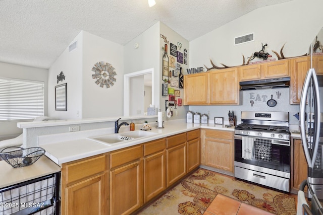 1861 W Sauvignon Dr, Tucson, AZ 85746 - kitchen featuring stainless steel gas range oven, a sink, under cabinet range hood, a peninsula, and light countertops