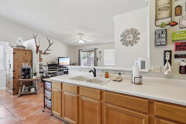 1861 W Sauvignon Dr, Tucson, AZ 85746 - kitchen with a sink, light tile patterned flooring, a textured ceiling, a ceiling fan, and light countertops