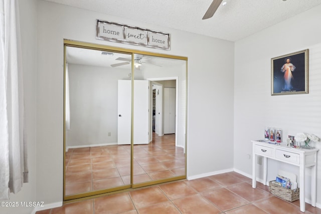 1861 W Sauvignon Dr, Tucson, AZ 85746 - dining area featuring ceiling fan, tile patterned flooring, baseboards, and a textured ceiling