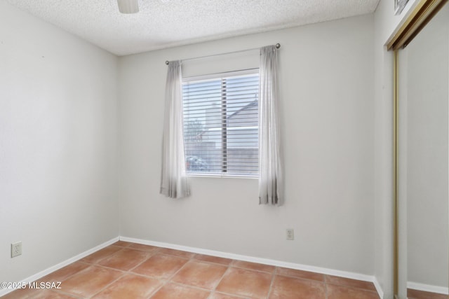1861 W Sauvignon Dr, Tucson, AZ 85746 - spare room featuring a textured ceiling, tile patterned flooring, and baseboards