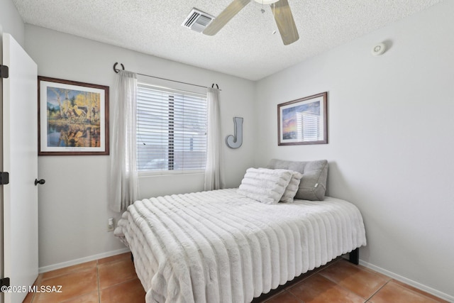 1861 W Sauvignon Dr, Tucson, AZ 85746 - tiled bedroom with baseboards, a textured ceiling, and ceiling fan
