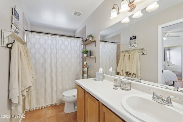 1861 W Sauvignon Dr, Tucson, AZ 85746 - ensuite bathroom featuring tile patterned flooring, vanity, toilet, ceiling fan, and a shower with shower curtain