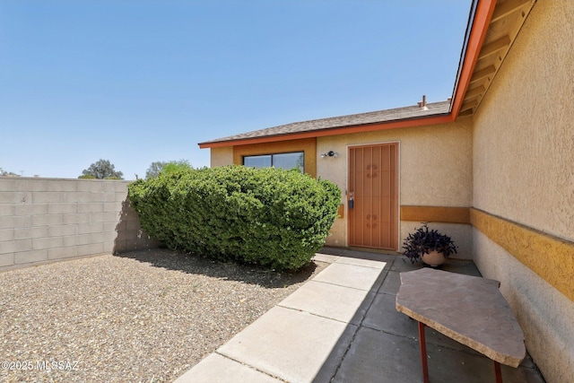 1861 W Sauvignon Dr, Tucson, AZ 85746 - view of exterior entry featuring stucco siding, fence, and a patio area