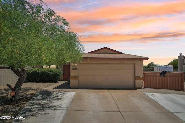 1861 W Sauvignon Dr, Tucson, AZ 85746 - view of front facade featuring driveway, stucco siding, a garage, and a gate