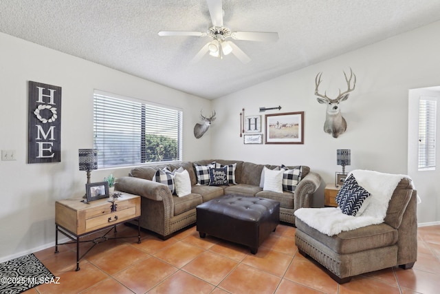 1861 W Sauvignon Dr, Tucson, AZ 85746 - living area featuring light tile patterned flooring, a textured ceiling, lofted ceiling, a ceiling fan, and baseboards