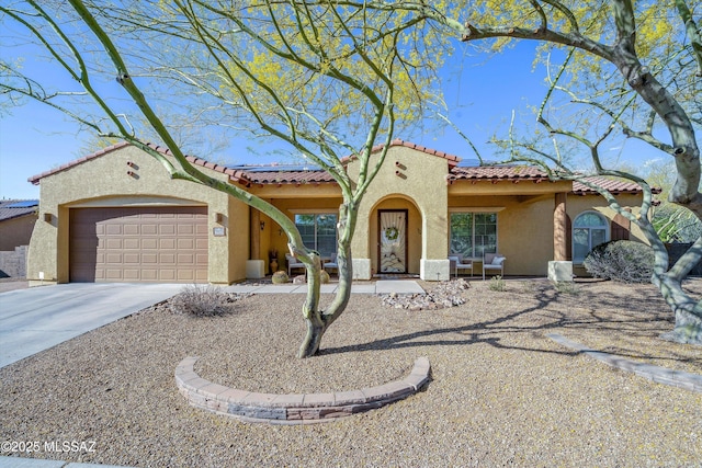 9451 S Via Bandera, Vail, AZ 85641 - mediterranean / spanish-style house featuring stucco siding, an attached garage, driveway, and a tiled roof