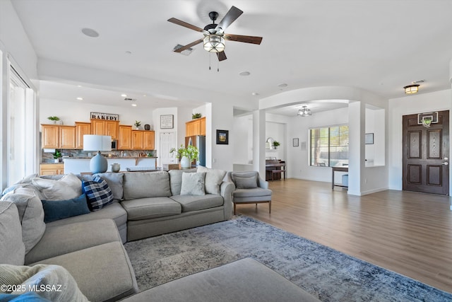9451 S Via Bandera, Vail, AZ 85641 - living room with ceiling fan, light wood-type flooring, arched walkways, recessed lighting, and baseboards