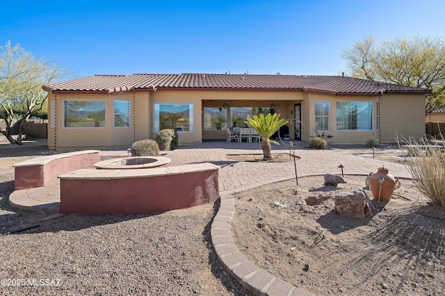 9451 S Via Bandera, Vail, AZ 85641 - back of property with an outdoor fire pit, a patio, stucco siding, and a tiled roof