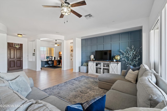 9451 S Via Bandera, Vail, AZ 85641 - living room with ceiling fan, light wood-type flooring, and arched walkways