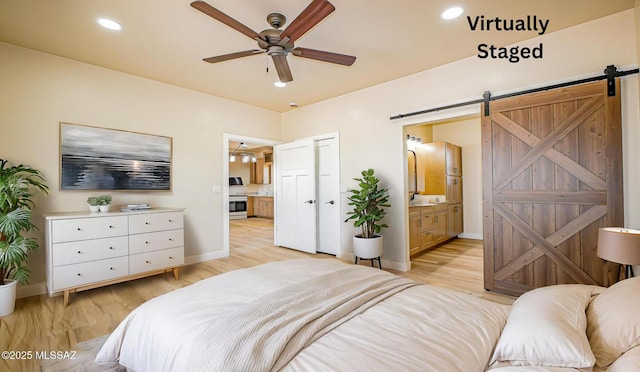 352 W Lee Trl, Safford, AZ 85546 - bedroom featuring a barn door, light wood-style floors, ensuite bath, baseboards, and recessed lighting