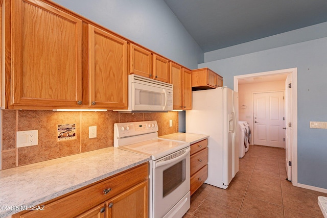 1176 W Trigger Ln, Cochise, AZ 85606 - kitchen featuring white appliances, washer and dryer, light tile patterned flooring, tasteful backsplash, and brown cabinetry