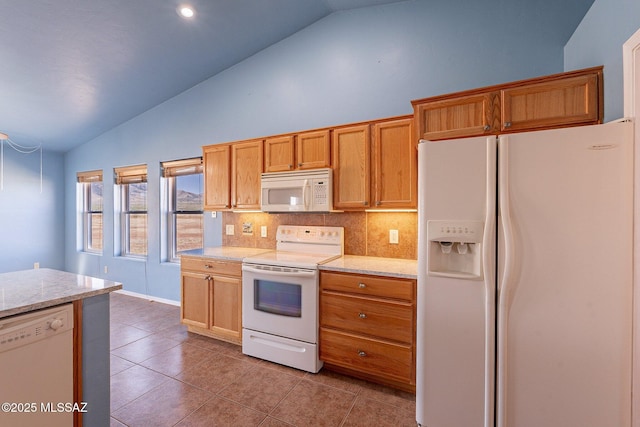 1176 W Trigger Ln, Cochise, AZ 85606 - kitchen with white appliances, backsplash, light tile patterned floors, high vaulted ceiling, and brown cabinetry