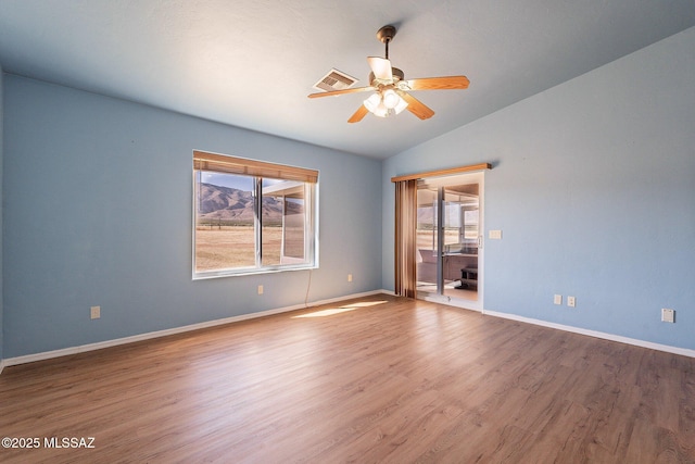 1176 W Trigger Ln, Cochise, AZ 85606 - spare room featuring healthy amount of natural light, vaulted ceiling, a ceiling fan, wood finished floors, and baseboards