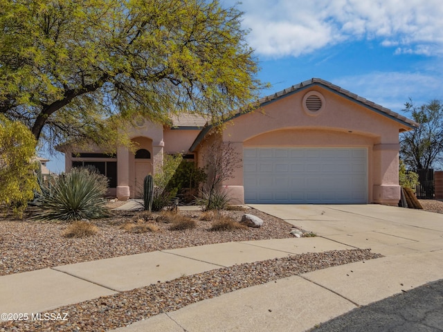 1797 W Naranja Dr, Oro Valley, AZ 85737 - mediterranean / spanish-style house with stucco siding, concrete driveway, a garage, and a tiled roof