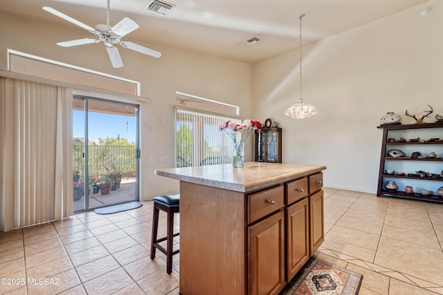 1797 W Naranja Dr, Oro Valley, AZ 85737 - kitchen featuring brown cabinets, a breakfast bar, high vaulted ceiling, light countertops, and decorative light fixtures