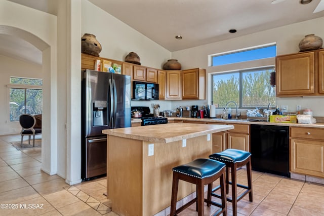 1797 W Naranja Dr, Oro Valley, AZ 85737 - kitchen with black appliances, a sink, light tile patterned flooring, light countertops, and a kitchen island