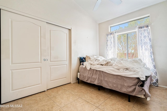 1797 W Naranja Dr, Oro Valley, AZ 85737 - bedroom with vaulted ceiling, light tile patterned floors, a closet, and a ceiling fan