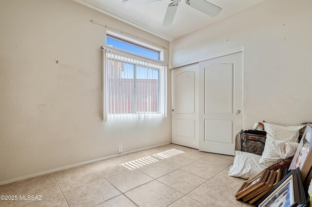 1797 W Naranja Dr, Oro Valley, AZ 85737 - bedroom featuring light tile patterned flooring, a closet, baseboards, and a ceiling fan