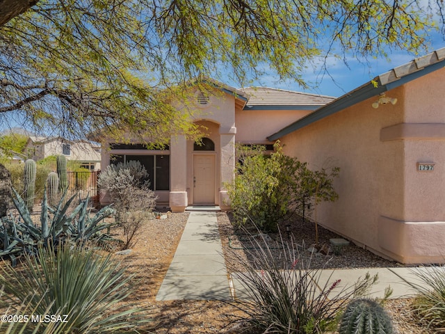1797 W Naranja Dr, Oro Valley, AZ 85737 - view of exterior entry featuring stucco siding and a tiled roof