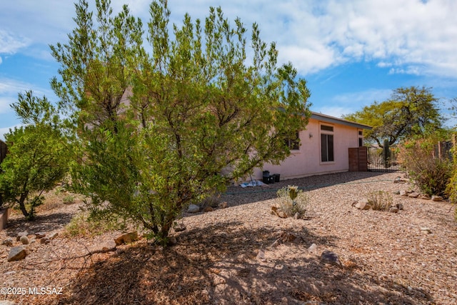 1797 W Naranja Dr, Oro Valley, AZ 85737 - view of home's exterior with fence, stucco siding, and a gate