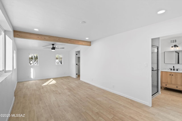 5011 E Scarlett St, Tucson, AZ 85711 - unfurnished living room featuring recessed lighting, light wood-style flooring, beamed ceiling, baseboards, and a sink