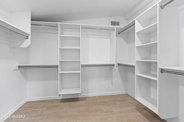 5011 E Scarlett St, Tucson, AZ 85711 - spacious closet featuring wood finished floors