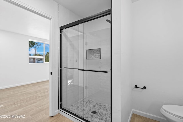 5011 E Scarlett St, Tucson, AZ 85711 - full bathroom featuring a shower stall, baseboards, toilet, and wood finished floors
