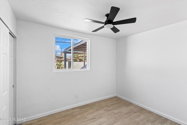 5011 E Scarlett St, Tucson, AZ 85711 - unfurnished bedroom with a closet, light wood-style floors, baseboards, and a ceiling fan