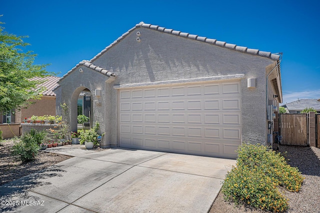 12625 N Wildrose Dr, Marana, AZ 85653 - view of front of property with an attached garage, stucco siding, driveway, a tiled roof, and fence